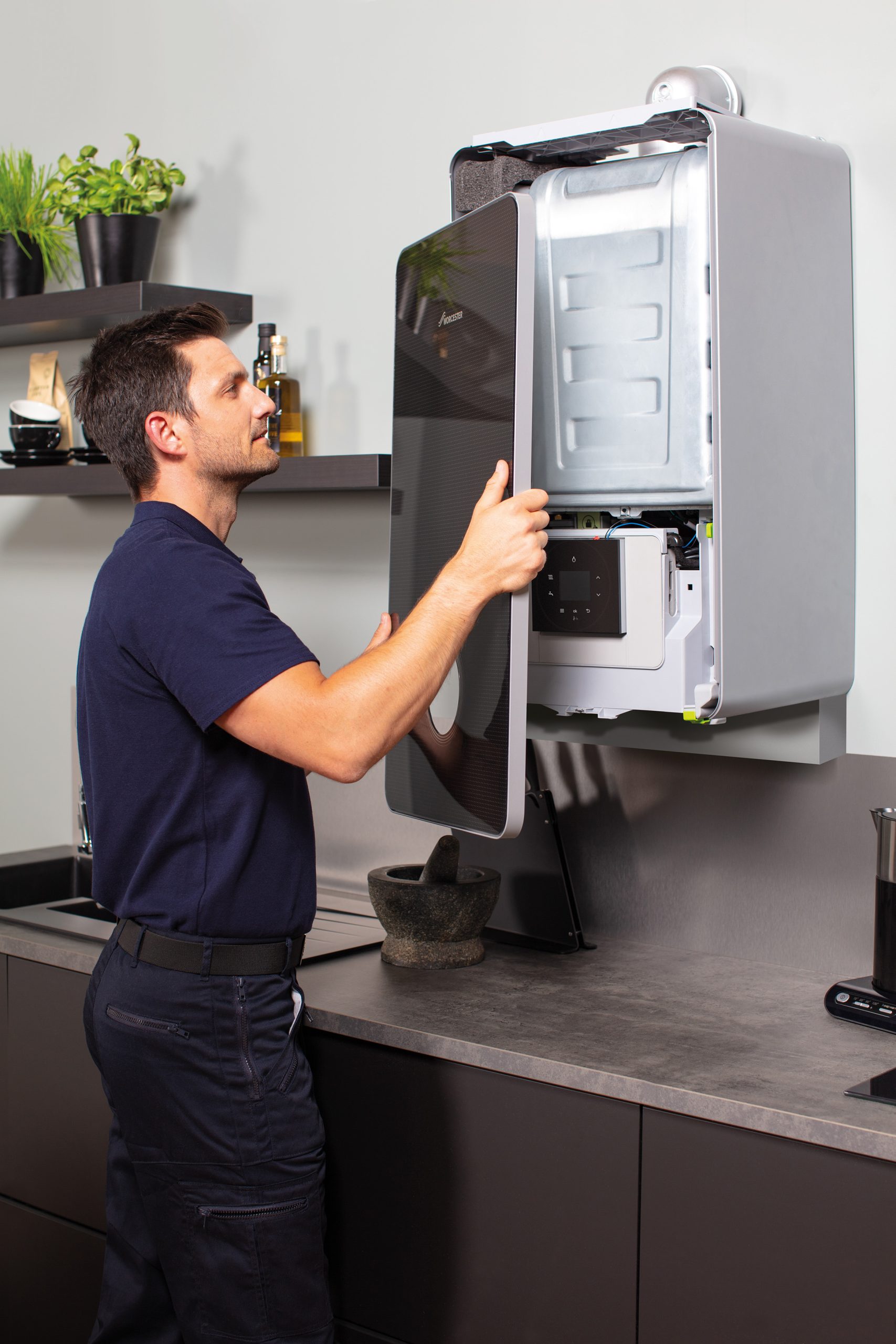 engineer fitting boiler